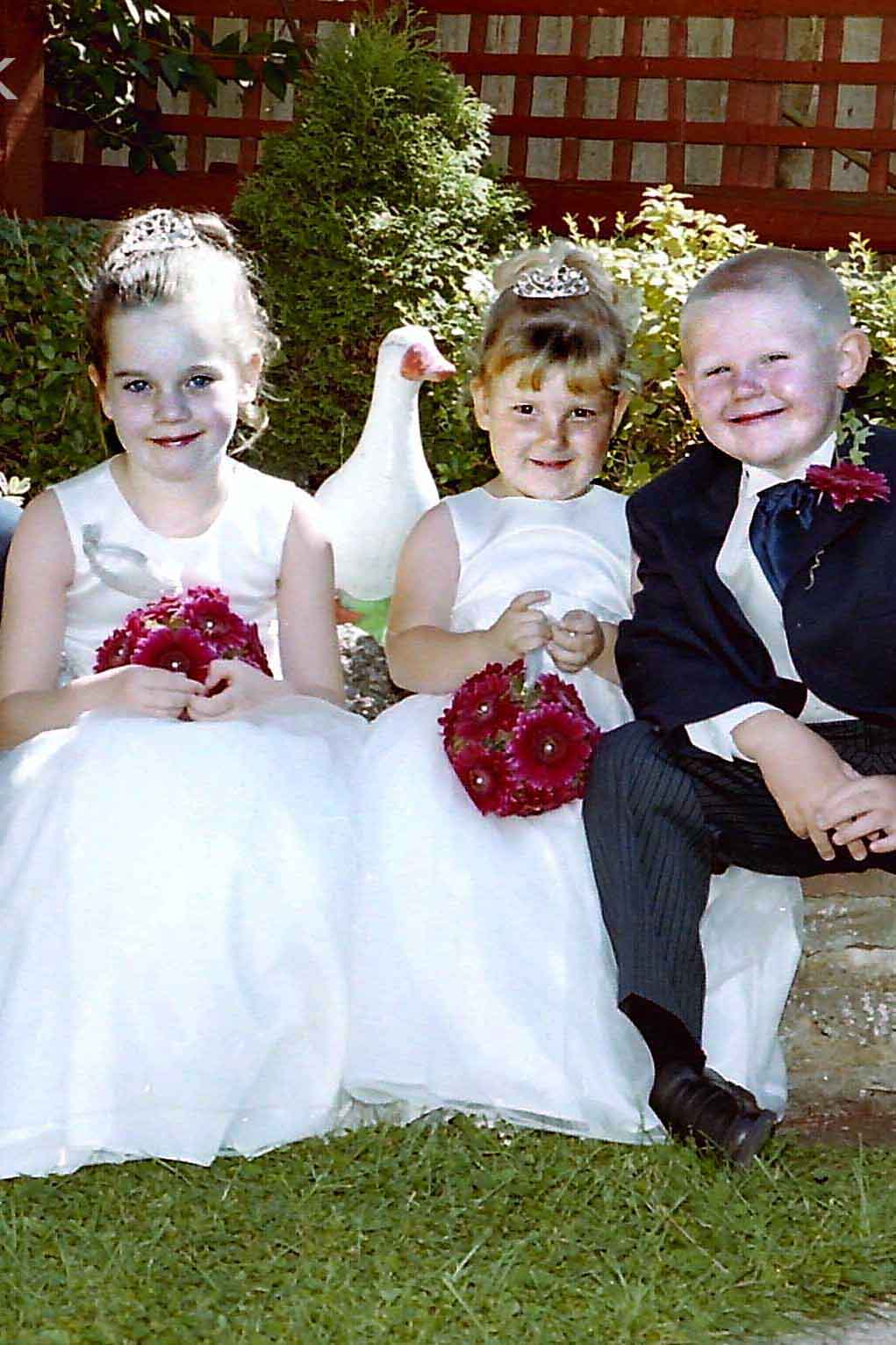 Beautiful picture of bridesmaids, pageboy and goose in Malden Rushett garden Kingston by Epsom Photography Surrey..